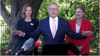 PM interrupted by angry demonstrators during media briefing.