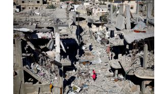 Despite the bombings in her father's neighborhood, the speaker's father refuses to evacuate.