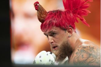 Jake Paul sports a unique hairstyle resembling a rooster as he prepares for his highly anticipated fight against Mike Tyson.