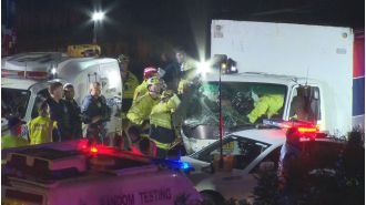 A driver was taken into custody for reportedly crashing into police vehicles during a chase.