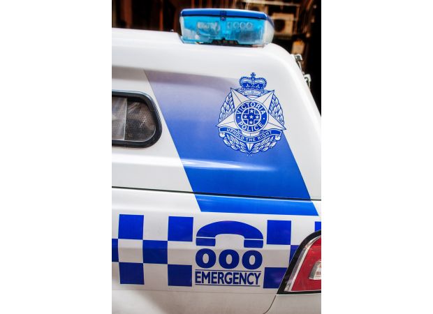 A woman was taken into custody following a close call between her car and a police vehicle.