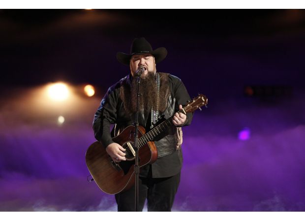 Voice contestant accidentally shoots himself and is taken to hospital.