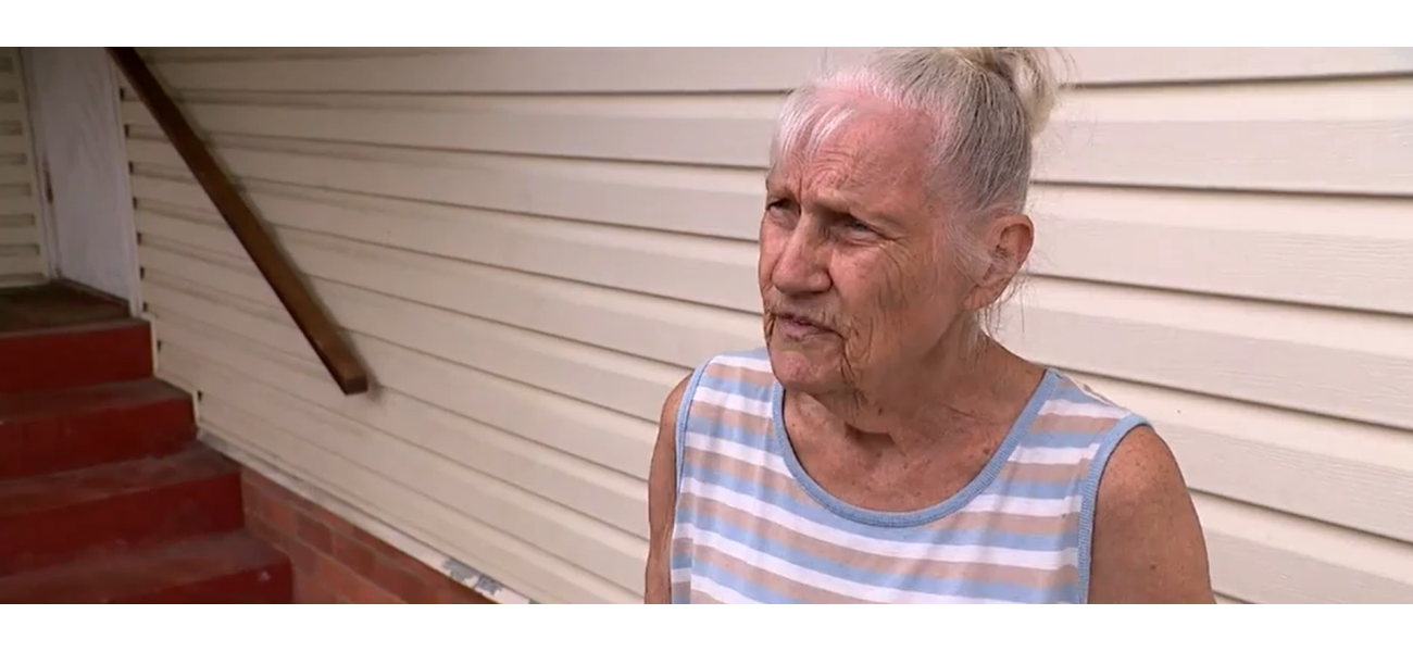 Possible paraphrase: A car, believed to be stolen, crashes into a house in Queensland, causing great distress to a woman.