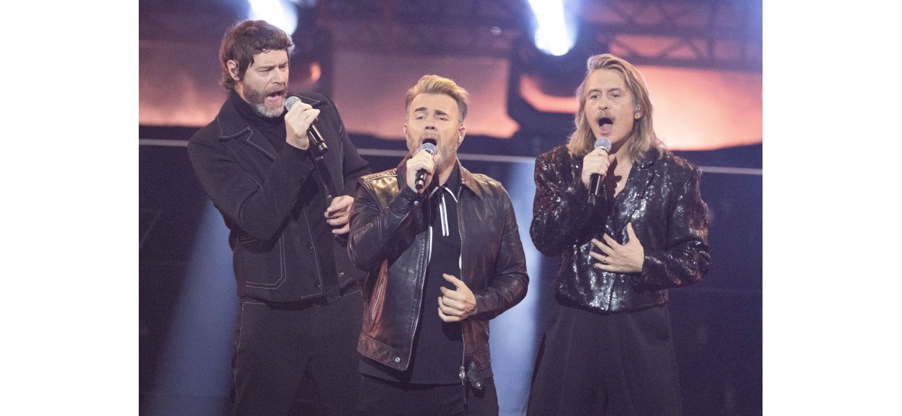 Robbie Williams is scared of re-opening old band wounds while Take That watches his biopic.
