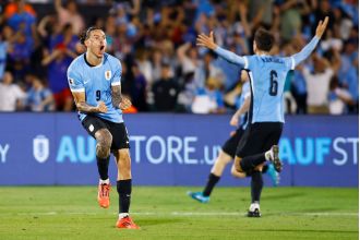 Nunez celebrates in front of past Liverpool opponent in Uruguay victory.
