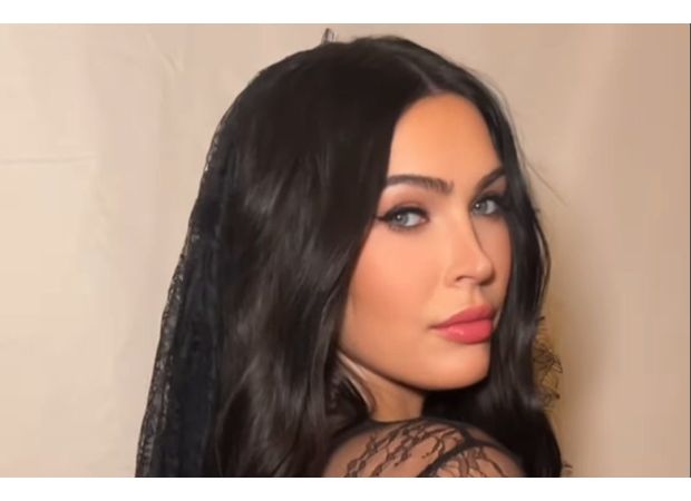 Megan Fox flaunts baby bump in risqué lingerie following unexpected absence from red carpet.