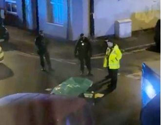 A man was detained for killing two people discovered deceased on a Manchester street.