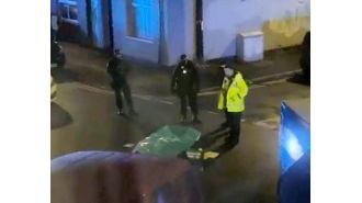 A man was detained for killing two people discovered deceased on a Manchester street.