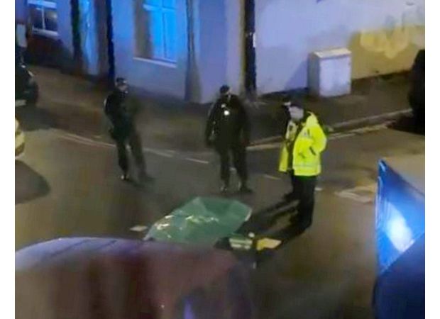 A man was detained for killing two people discovered deceased on a Manchester street.