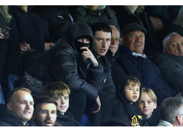 A top English player attends a lower league game without being recognized, following their withdrawal from the national team.