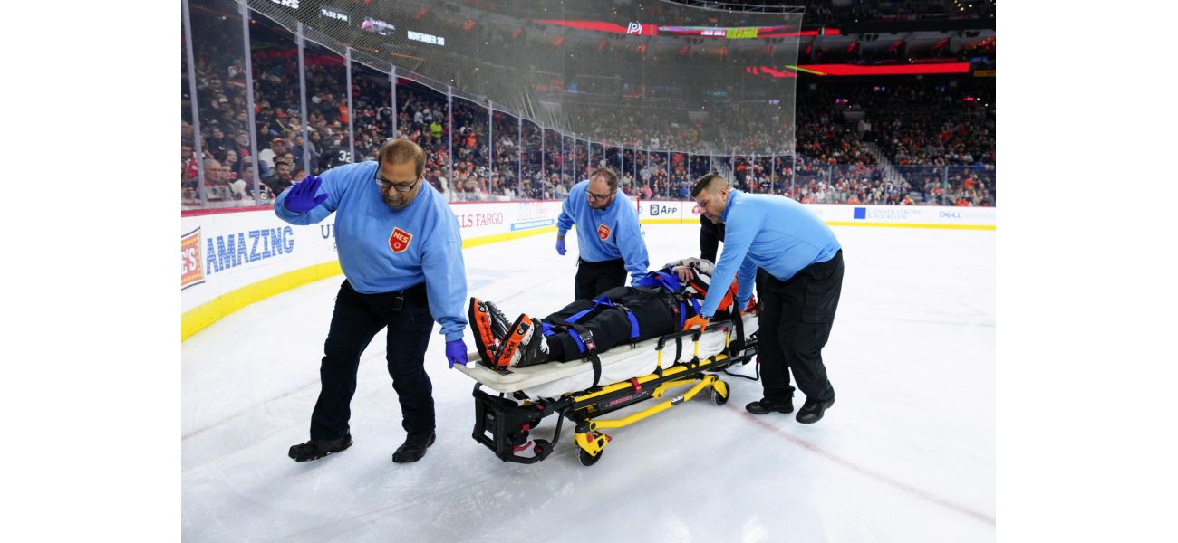 NHL referee Mitch Dunning can talk and move after getting hit in Avs-Flyers game.