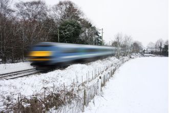 Bad weather disrupts travel in UK with cancelled trains and icy roads.