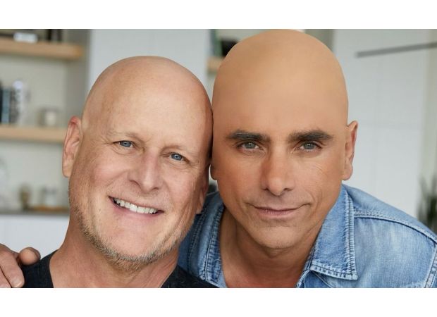 John Stamos angered fans with a photo of himself wearing a bald cap in support of his co-star's cancer diagnosis.