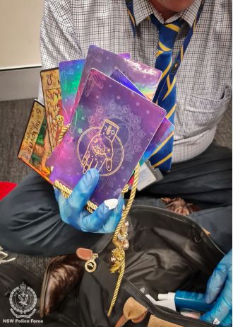 Police arrested a woman for fraud after seizing items like tarot cards and a crystal ball that were allegedly being used in a psychic scam.