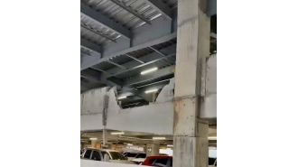 A fatal car crash at a shopping center results in one death as the car lands on a kiosk.