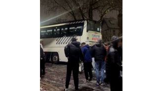 Passengers prevent National Express coach from sliding down icy hill.
