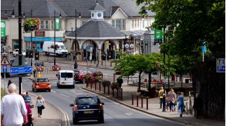 14-year-old girl and man critically injured in town center when van collides with pedestrians.