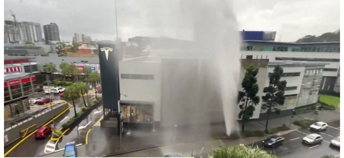 A broken water main in Brisbane causes a fountain of water and drenches the surrounding area.