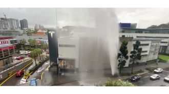 A broken water main in Brisbane causes a fountain of water and drenches the surrounding area.
