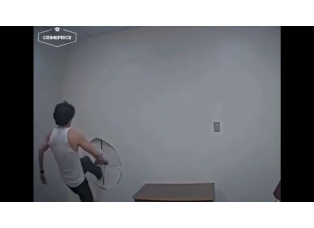 Suspect escapes by breaking through wall in interrogation room.
