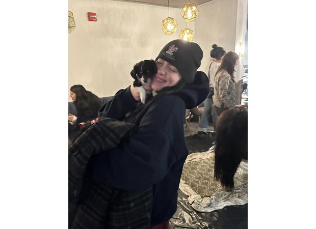 Billie Eilish cuddles with rescue dog and pony before performing in Denver.
