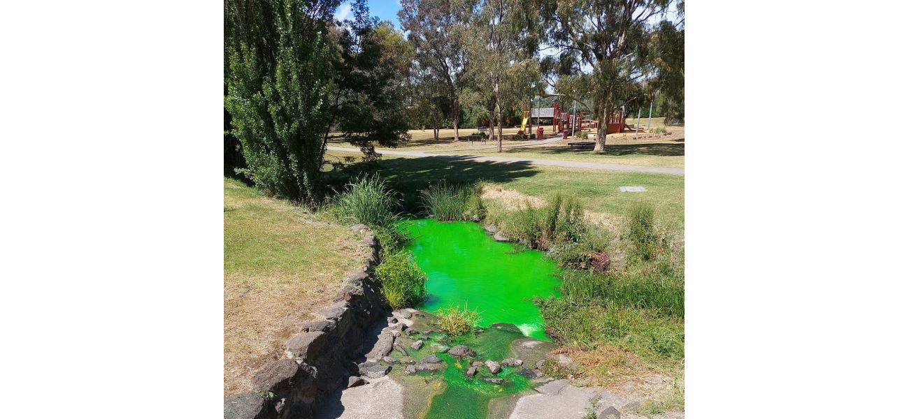 Authorities advise against coming into contact with the bright green creek.