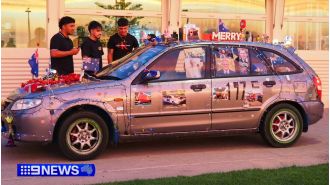 Intoxicated driver adorns car, drives through crowded square.