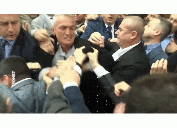 A physical altercation breaks out in the country's parliament, resulting in accusations and blame being placed on those involved.