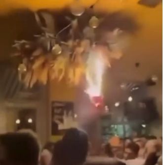Several individuals injured following a large bar fire caused by birthday cake sparklers.