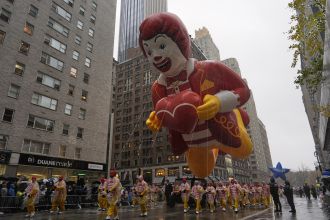 The Macy's Thanksgiving Day Parade included large balloons, rainy conditions, and 21 arrests of protesters.