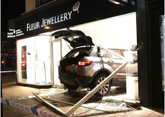Thieves crash car into store and escape with stolen jewelry.