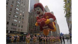 The Macy's Thanksgiving Day Parade included large balloons, rainy conditions, and 21 arrests of protesters.