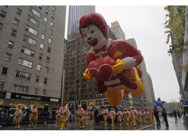 The Macy's Thanksgiving Day Parade included large balloons, rainy conditions, and 21 arrests of protesters.
