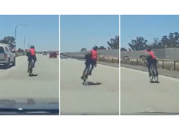 A cyclist was seen riding recklessly on a crowded motorway in Adelaide.