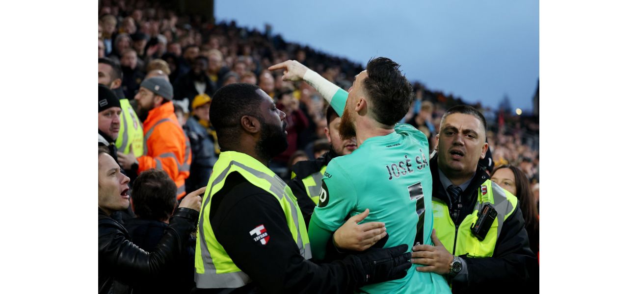 Wolves' goalie Jose Sa intervenes with irate supporter in loss to Bournemouth.