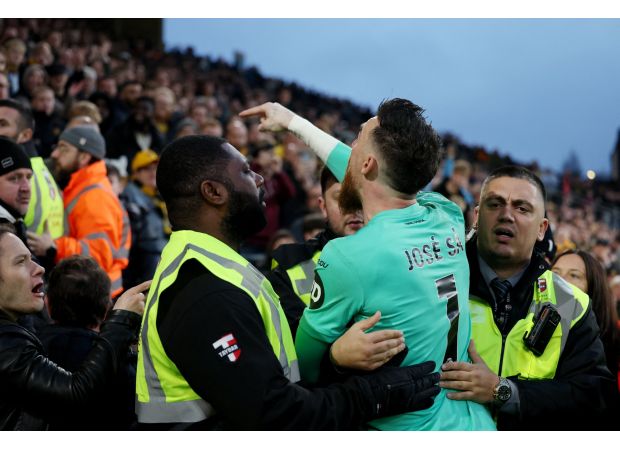 Wolves' goalie Jose Sa intervenes with irate supporter in loss to Bournemouth.