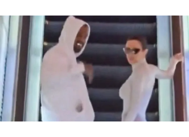 Kanye West shows off his expensive titanium teeth and avoids legal troubles in Tokyo.