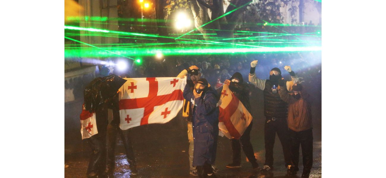 Russia cautions Georgia against following in Ukraine's footsteps as violence continues for fourth night.