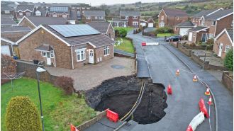 A large sinkhole appeared on a housing estate, causing many people to evacuate.