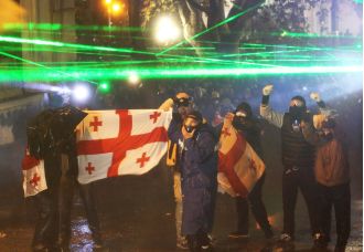 Russia cautions Georgia against following in Ukraine's footsteps as violence continues for fourth night.