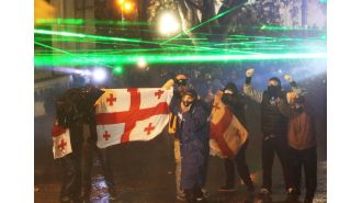 Russia cautions Georgia against following in Ukraine's footsteps as violence continues for fourth night.