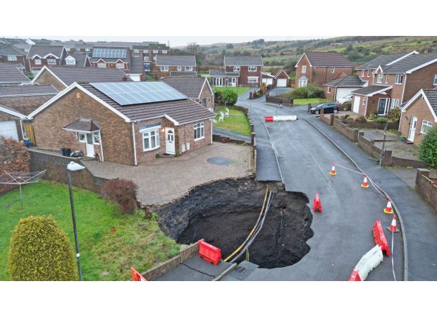 A large sinkhole appeared on a housing estate, causing many people to evacuate.