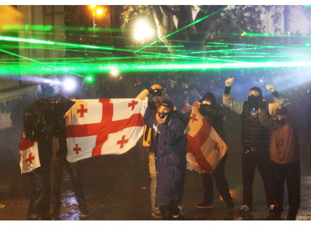 Russia cautions Georgia against following in Ukraine's footsteps as violence continues for fourth night.