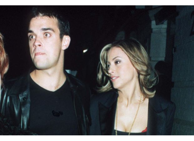 The article explores Robbie Williams and Nicole Appleton's relationship following Williams' revelation about their abortion.