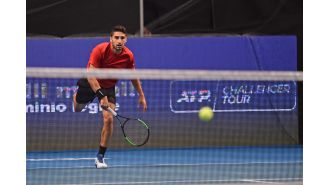 A professional tennis player has a brain bleed while playing and is quickly taken to the hospital.