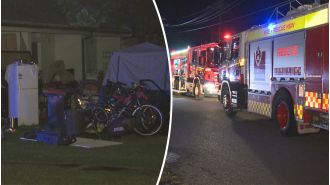 Firefighters are having difficulty putting out a fire at a hoarder's property in Sydney.