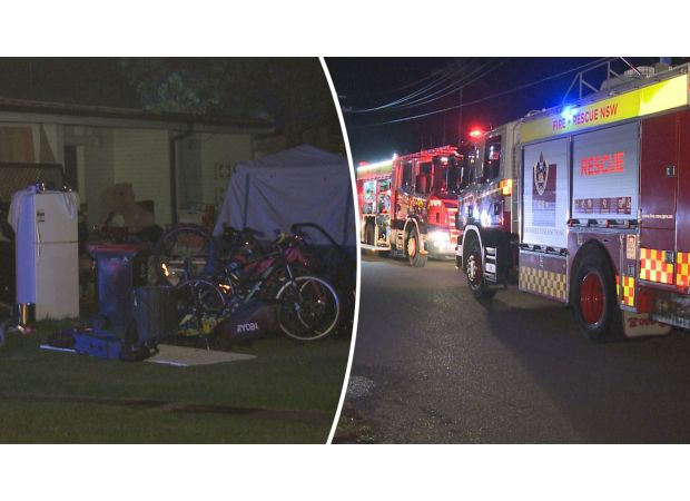 Firefighters are having difficulty putting out a fire at a hoarder's property in Sydney.