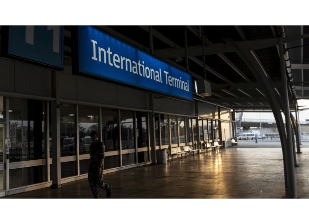 Man assaults security at Sydney Airport after forcing his way onto a plane.