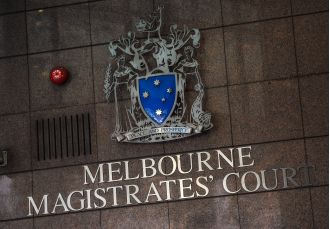 A person charged with murder in Melbourne's western region weeps during their appearance in court.