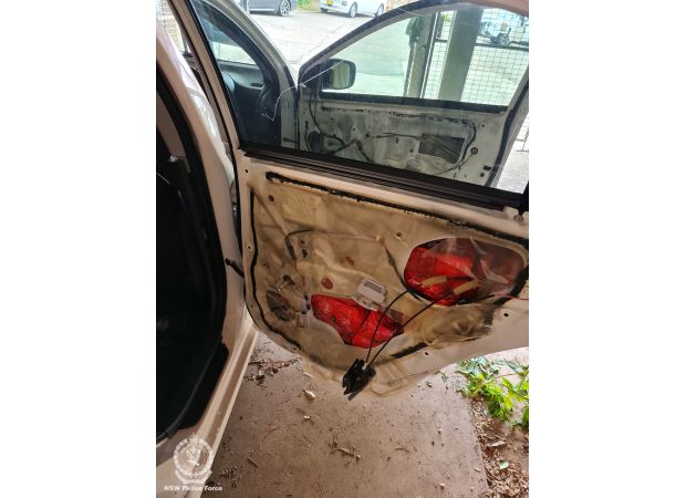 A Putin photo was used as a cover to hide $18 million worth of drugs concealed in car doors.